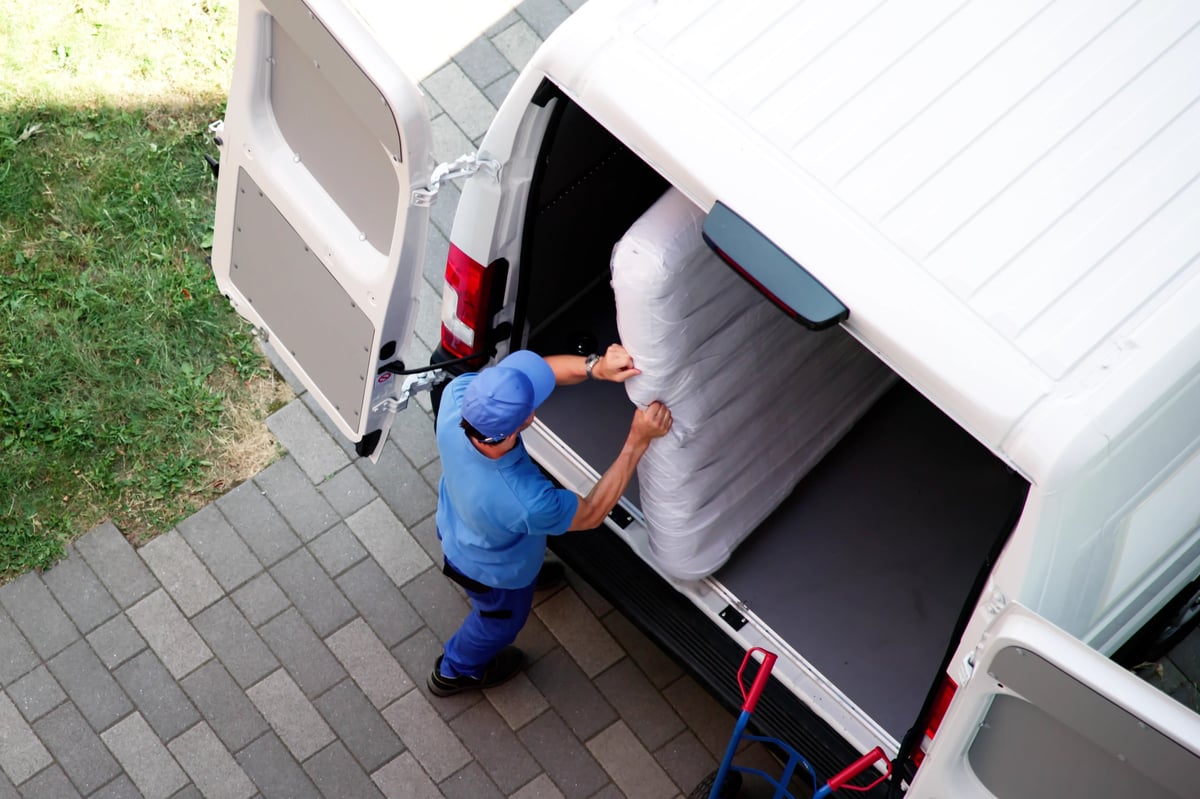JunkPal team loading furniture and boxes from an Ottawa estate home into a removal truck during a full cleanout.