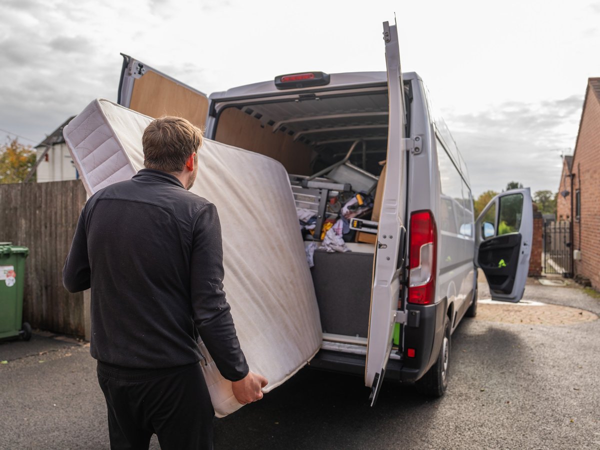 Two-person crew carrying a mattress out of a Kanata townhome during an estate cleanout in Ottawa.